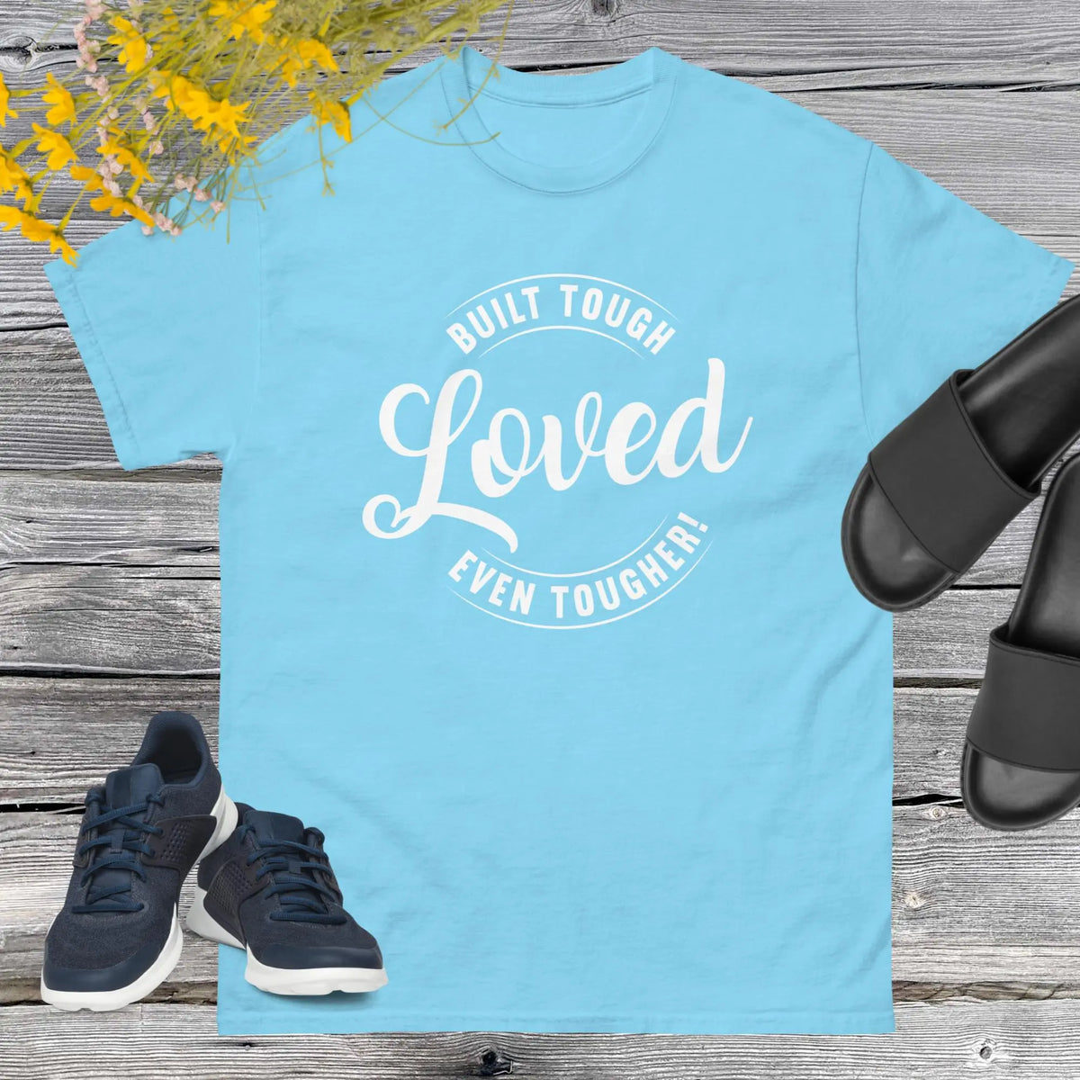"Built Tough, Loved Even Tougher" T-shirt is bold yet heartwarming quote emblazoned on the front speaks volumes about the resilience and love inherent in fatherhood. Whether he's fixing things around the house, giving sage advice, or simply being there through thick and thin, this shirt is a testament to the unwavering strength and tenderness of dads everywhere.