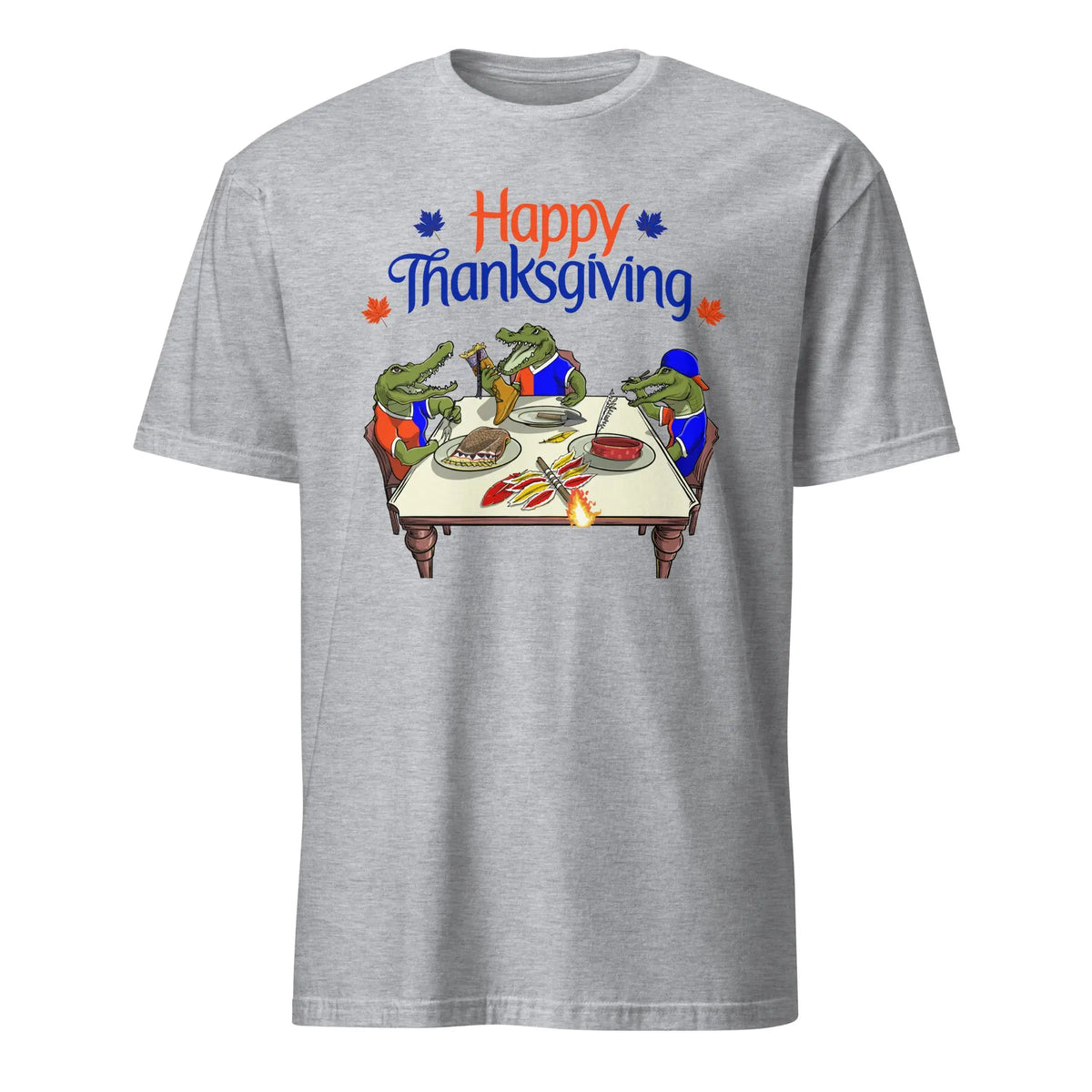 Grey t-shirt with ‘Happy Thanksgiving’ text above three cartoon Florida Gators carving and serving a cooked Seminole mascot at a holiday dinner table