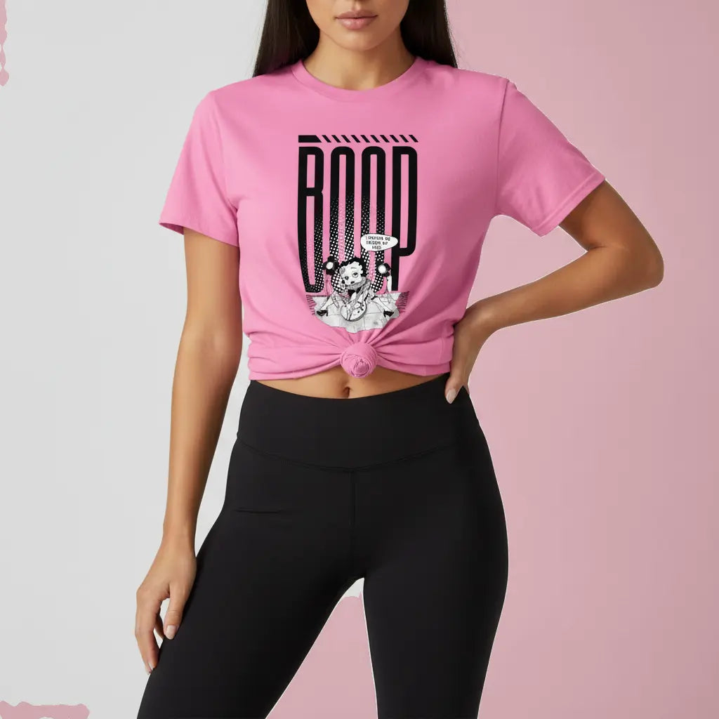 Woman wearing a pink graphic tee with a Betty Boop-inspired rock star design, styled with black leggings and a front knot