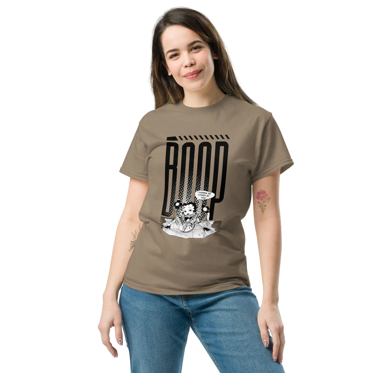 Woman wearing a brown graphic tee with a Betty Boop-inspired rock star design, styled with denim jeans