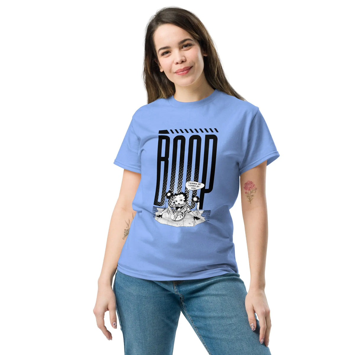 Woman wearing a Carolina Blue graphic tee with a Betty Boop-inspired rock star design, styled with blue denim jeans