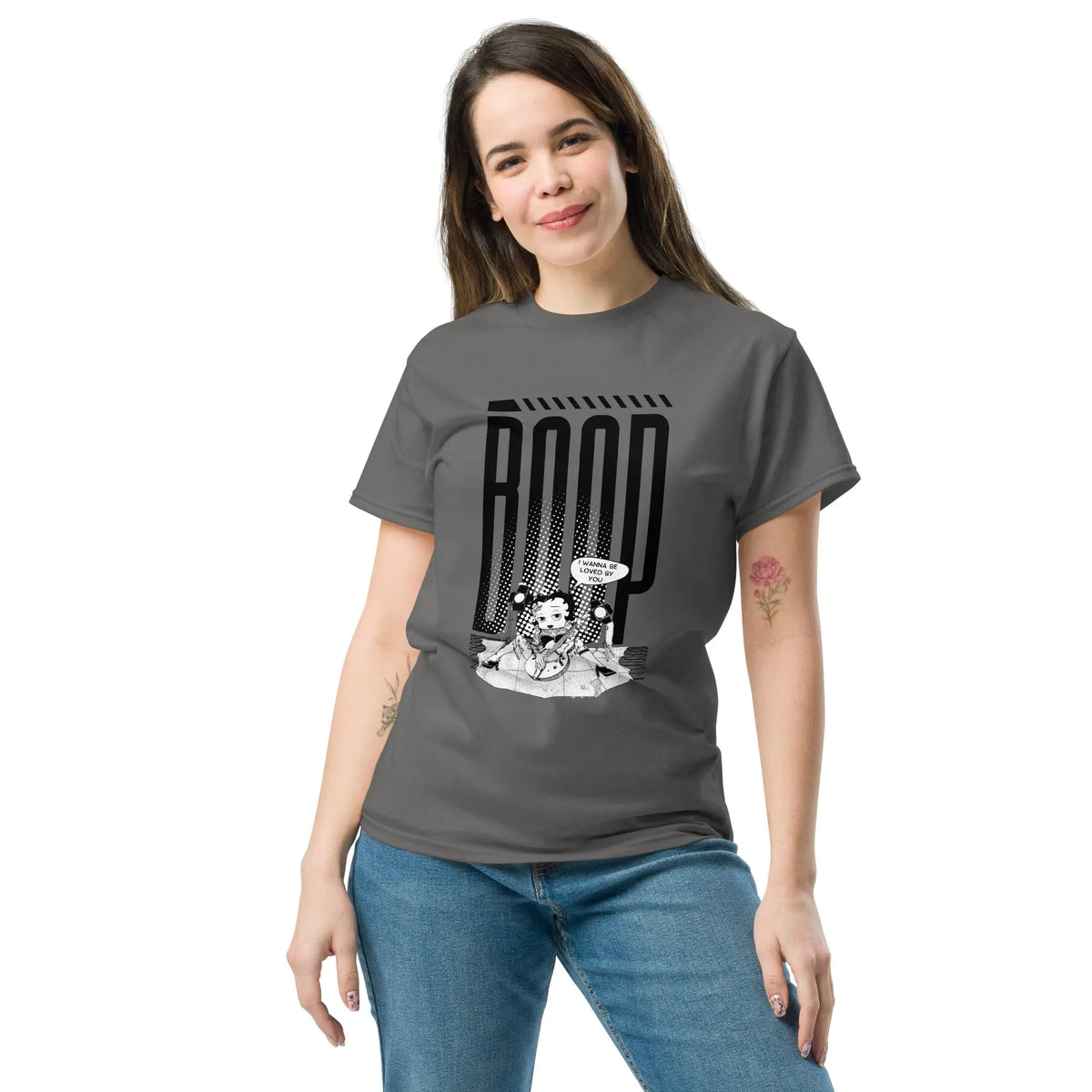 Woman wearing a Charcoal graphic tee with a Betty Boop-inspired rock star design, styled with blue denim jeans