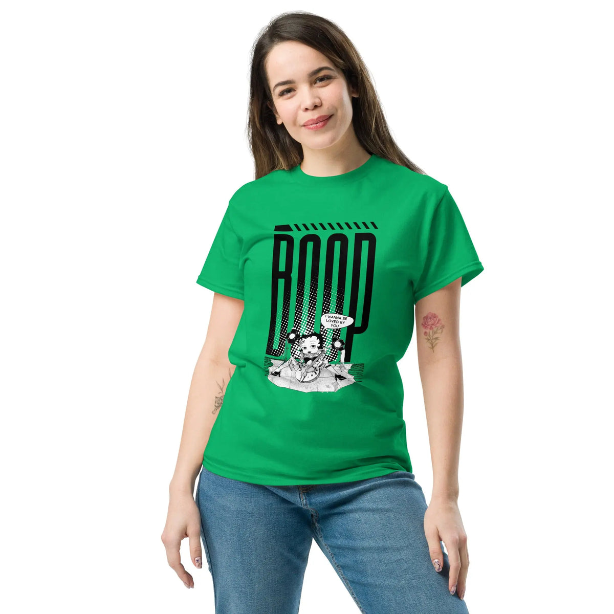 Woman wearing an Irish Green graphic tee with a Betty Boop-inspired rock star design, styled with blue denim jeans