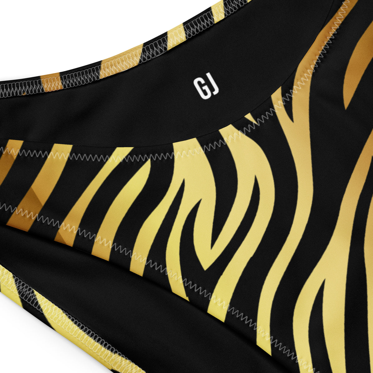 Closeup of a Black and gold zebra print bandeau bikini with strapless top and V-cut high-leg bottom