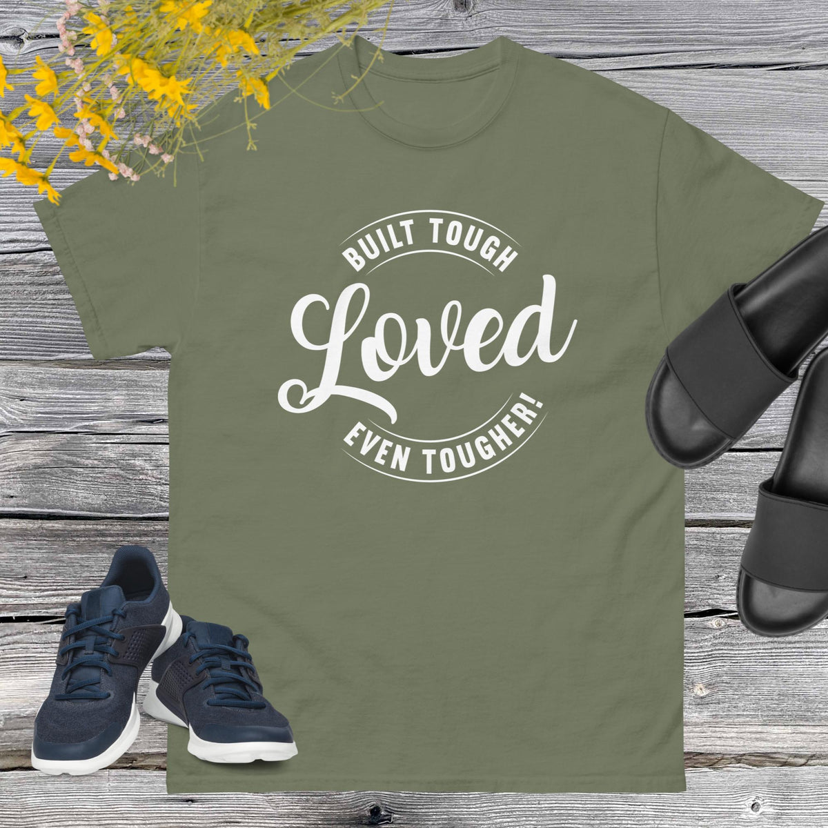 "Built Tough, Loved Even Tougher" T-shirt is bold yet heartwarming quote emblazoned on the front speaks volumes about the resilience and love inherent in fatherhood. Whether he's fixing things around the house, giving sage advice, or simply being there through thick and thin, this shirt is a testament to the unwavering strength and tenderness of dads everywhere.