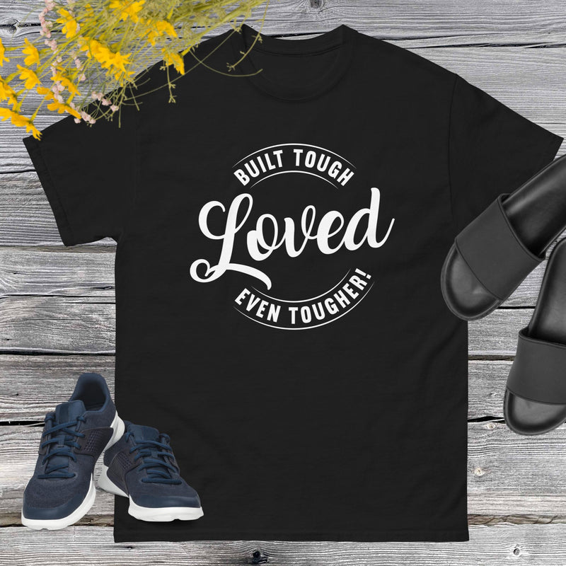 "Built Tough, Loved Even Tougher" T-shirt is bold yet heartwarming quote emblazoned on the front speaks volumes about the resilience and love inherent in fatherhood. Whether he's fixing things around the house, giving sage advice, or simply being there through thick and thin, this shirt is a testament to the unwavering strength and tenderness of dads everywhere.