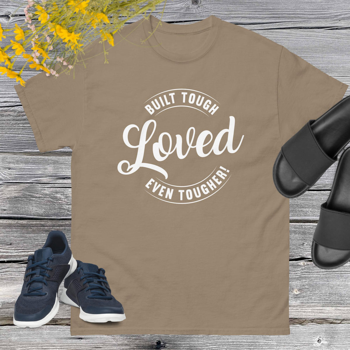 "Built Tough, Loved Even Tougher" T-shirt is bold yet heartwarming quote emblazoned on the front speaks volumes about the resilience and love inherent in fatherhood. Whether he's fixing things around the house, giving sage advice, or simply being there through thick and thin, this shirt is a testament to the unwavering strength and tenderness of dads everywhere.