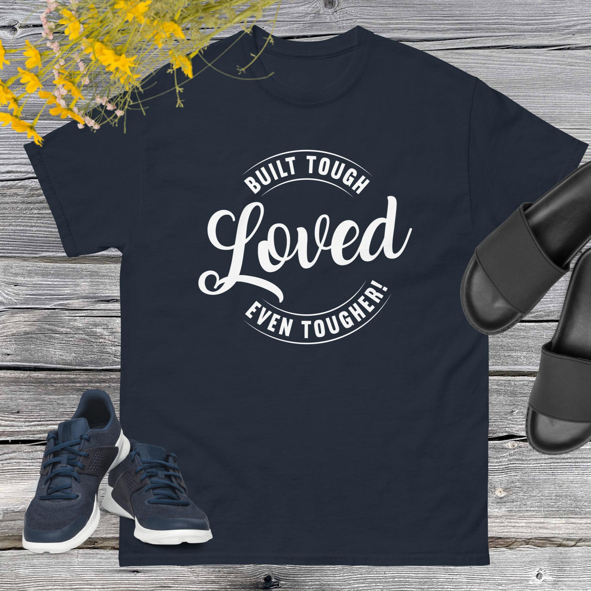 "Built Tough, Loved Even Tougher" T-shirt is bold yet heartwarming quote emblazoned on the front speaks volumes about the resilience and love inherent in fatherhood. Whether he's fixing things around the house, giving sage advice, or simply being there through thick and thin, this shirt is a testament to the unwavering strength and tenderness of dads everywhere.