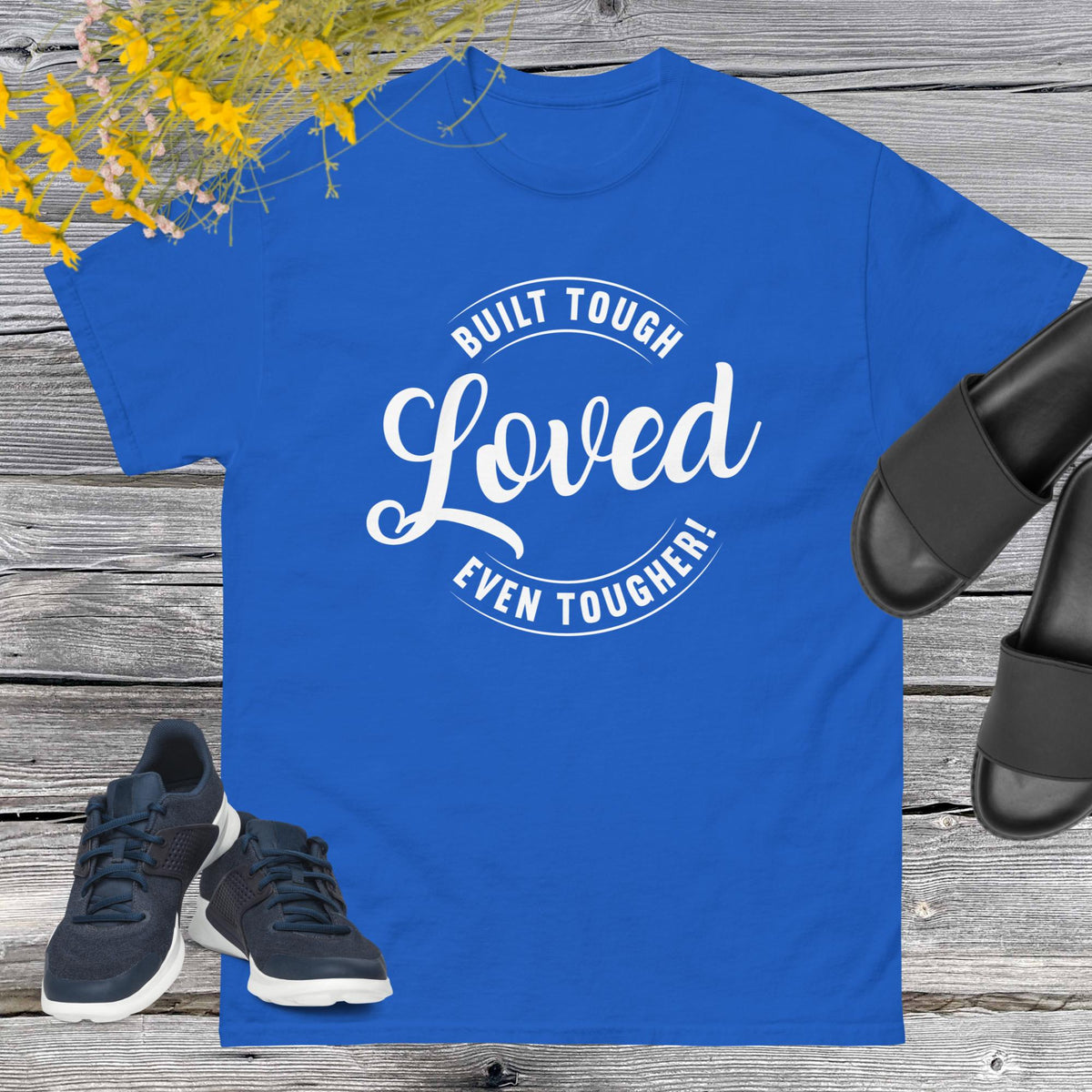 "Built Tough, Loved Even Tougher" T-shirt is bold yet heartwarming quote emblazoned on the front speaks volumes about the resilience and love inherent in fatherhood. Whether he's fixing things around the house, giving sage advice, or simply being there through thick and thin, this shirt is a testament to the unwavering strength and tenderness of dads everywhere.