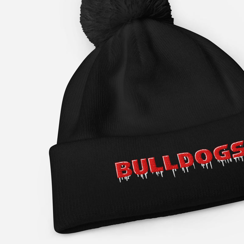 Close up of a Black pom pom beanie with red and white embroidered Bulldogs lettering and icy drip-style accents on the cuff