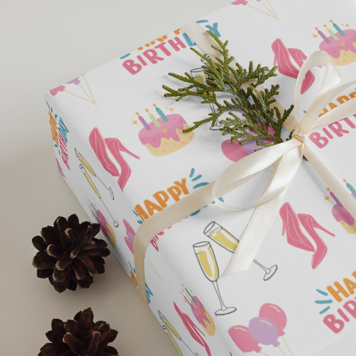White birthday wrapping paper with pink heels, cakes, balloons, champagne glasses, and colorful Happy Birthday lettering