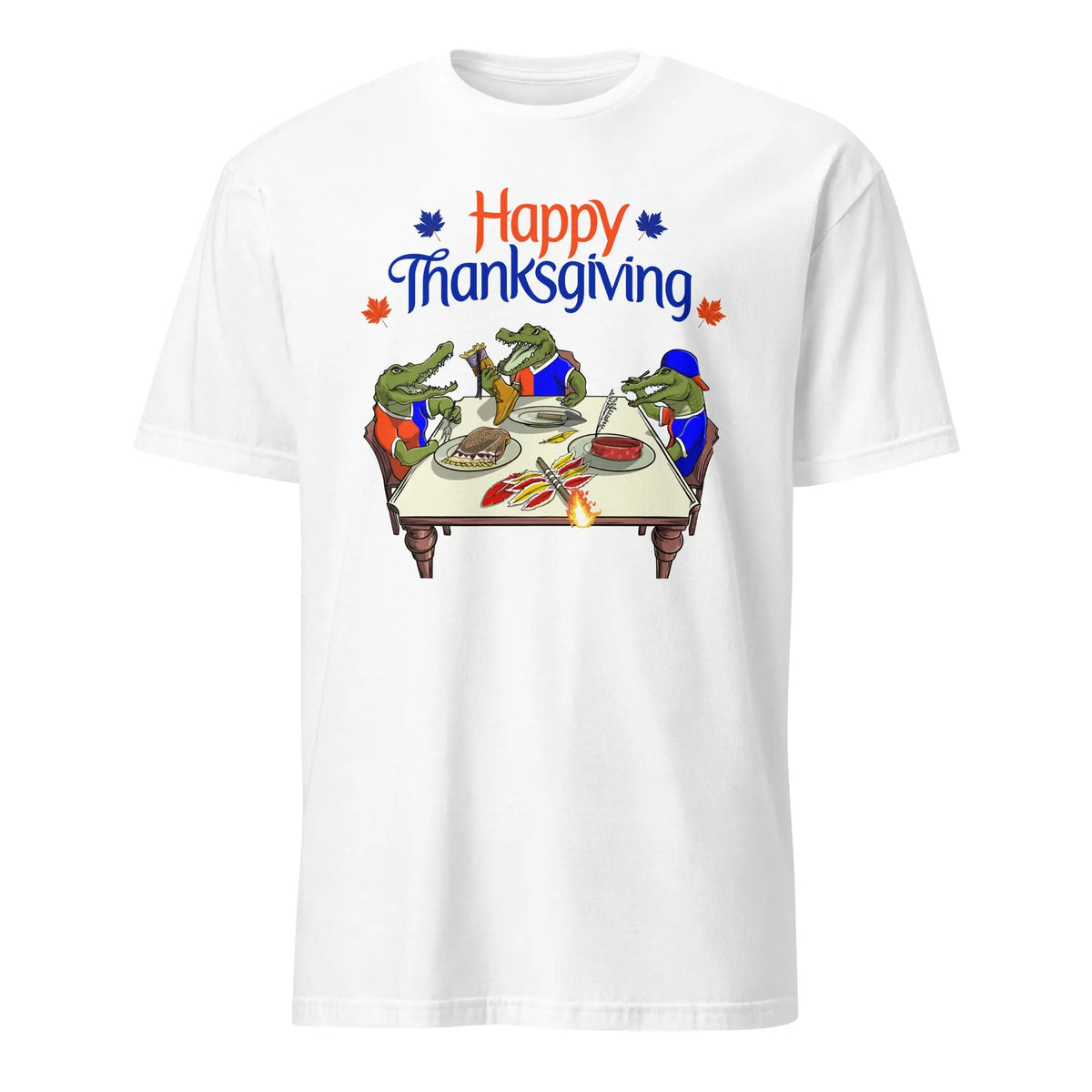 White t-shirt with ‘Happy Thanksgiving’ text above three cartoon Florida Gators carving and serving a cooked Seminole mascot at a holiday dinner table