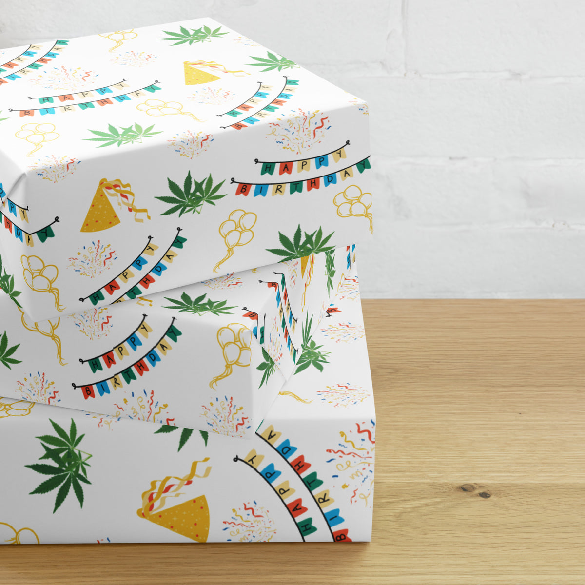 White cannabis-themed birthday wrapping paper with colorful banners, party hats, confetti, balloons, and green leaves