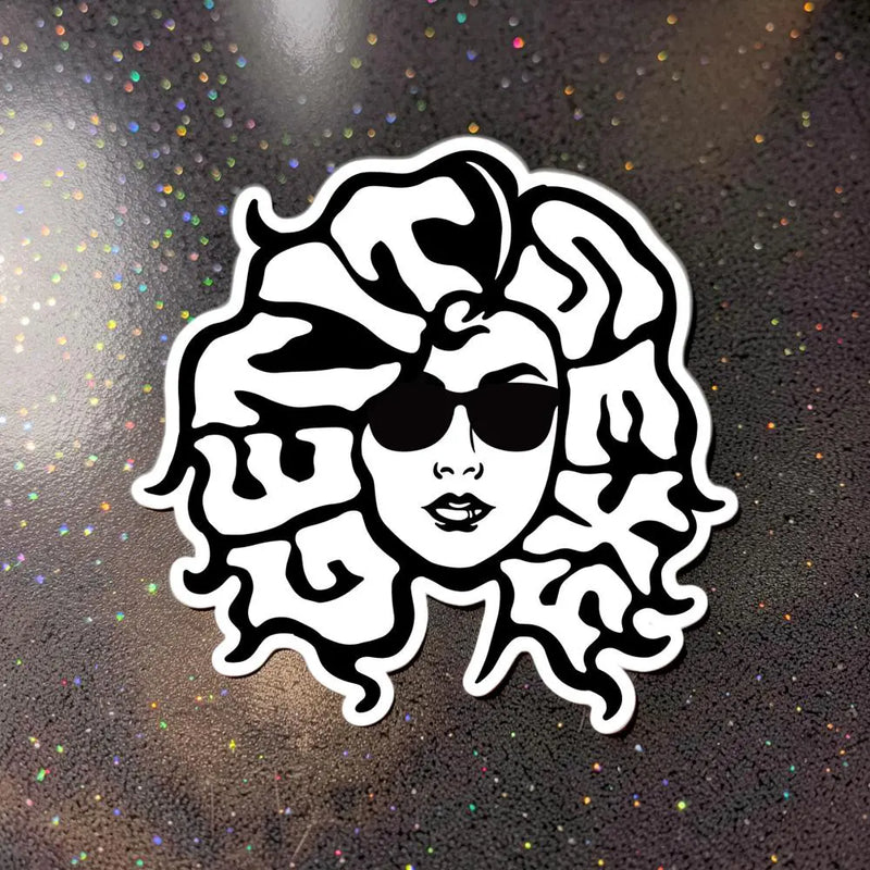 Black and white sticker of a woman in sunglasses with typography-style hair design