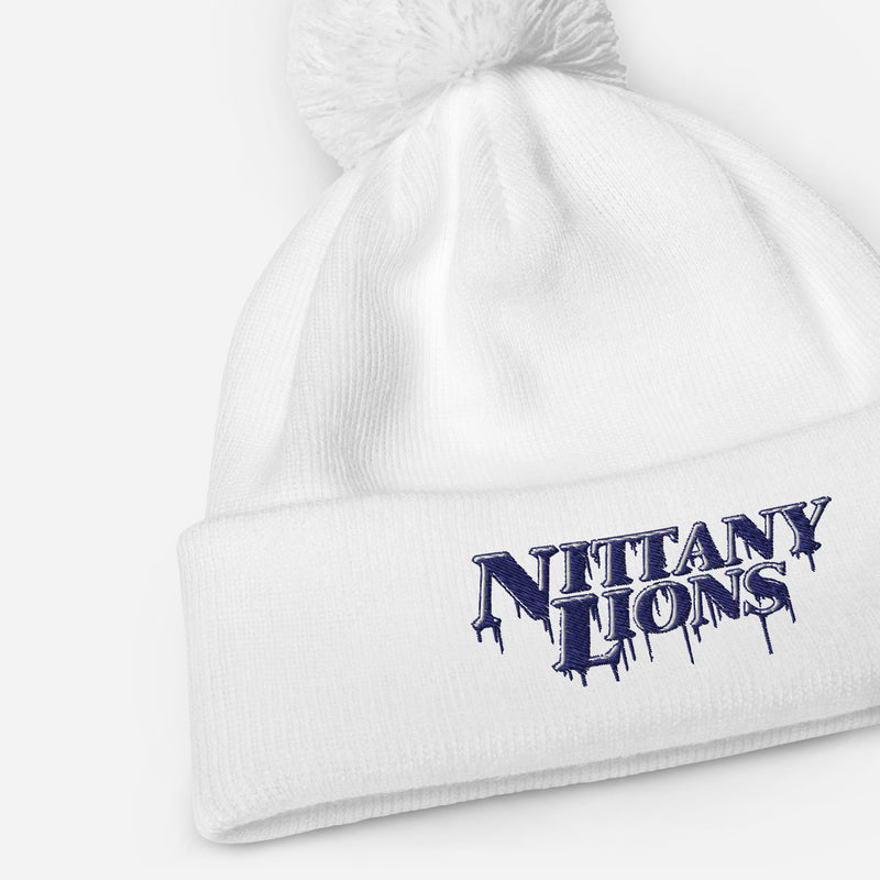 White pom pom beanie with bold embroidered Nittany Lions lettering on the front cuff