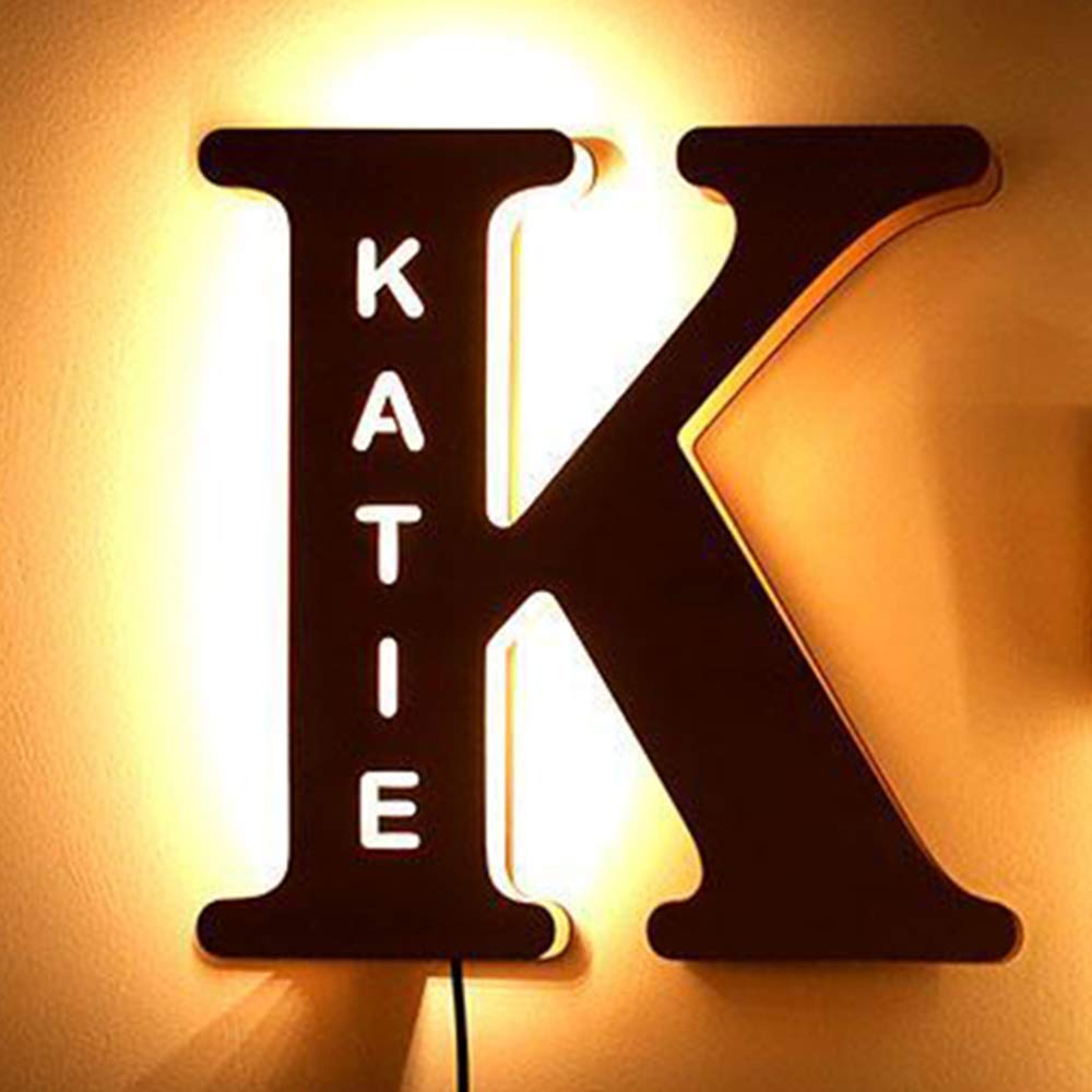 Personalized wooden alphabet LED night light with hollow-engraved letter and custom name illuminated by a soft ambient glow
