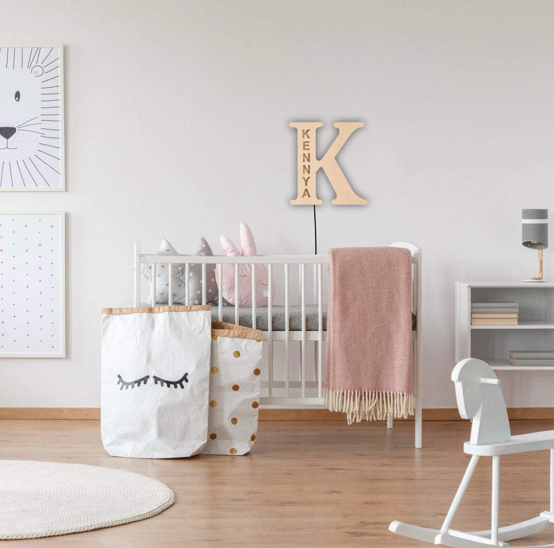 Personalized wooden alphabet LED night light with hollow-engraved letter and custom name illuminated by a soft ambient glow