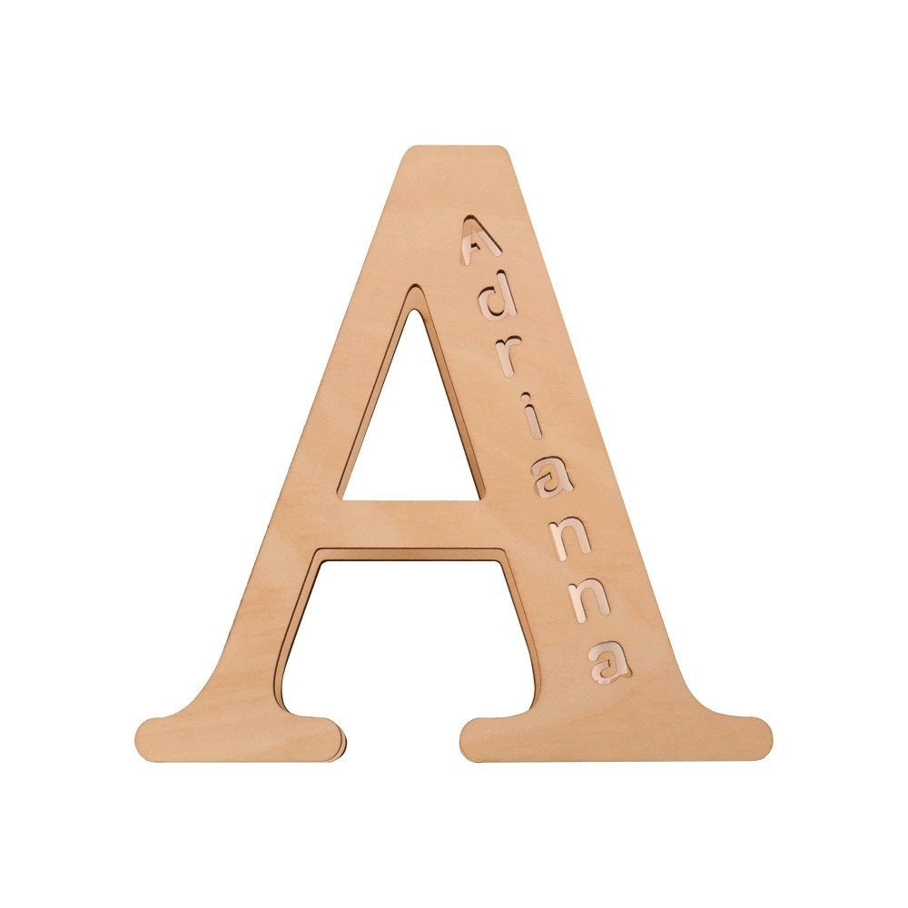 Personalized wooden alphabet LED night light with hollow-engraved letter and custom name illuminated by a soft ambient glow