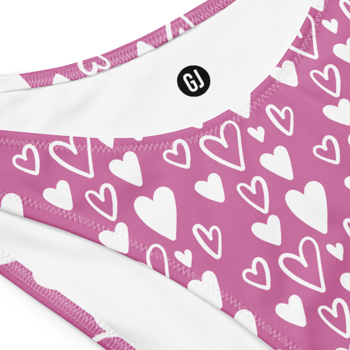 Close up of a Pink and white heart print bandeau bikini with strapless top and high-waist high-leg bottom