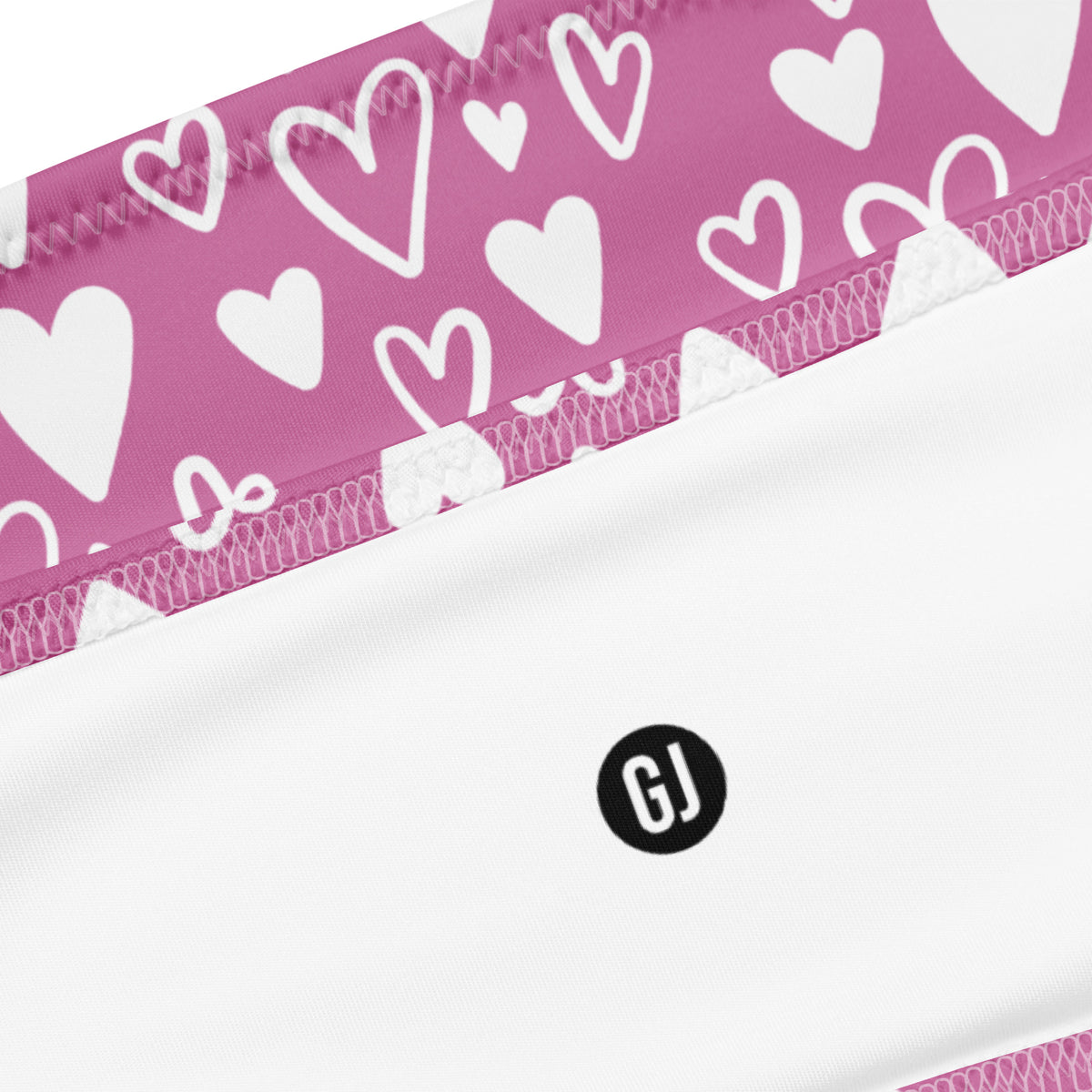 Close up of a Pink and white heart print bandeau bikini with strapless top and high-waist high-leg bottom
