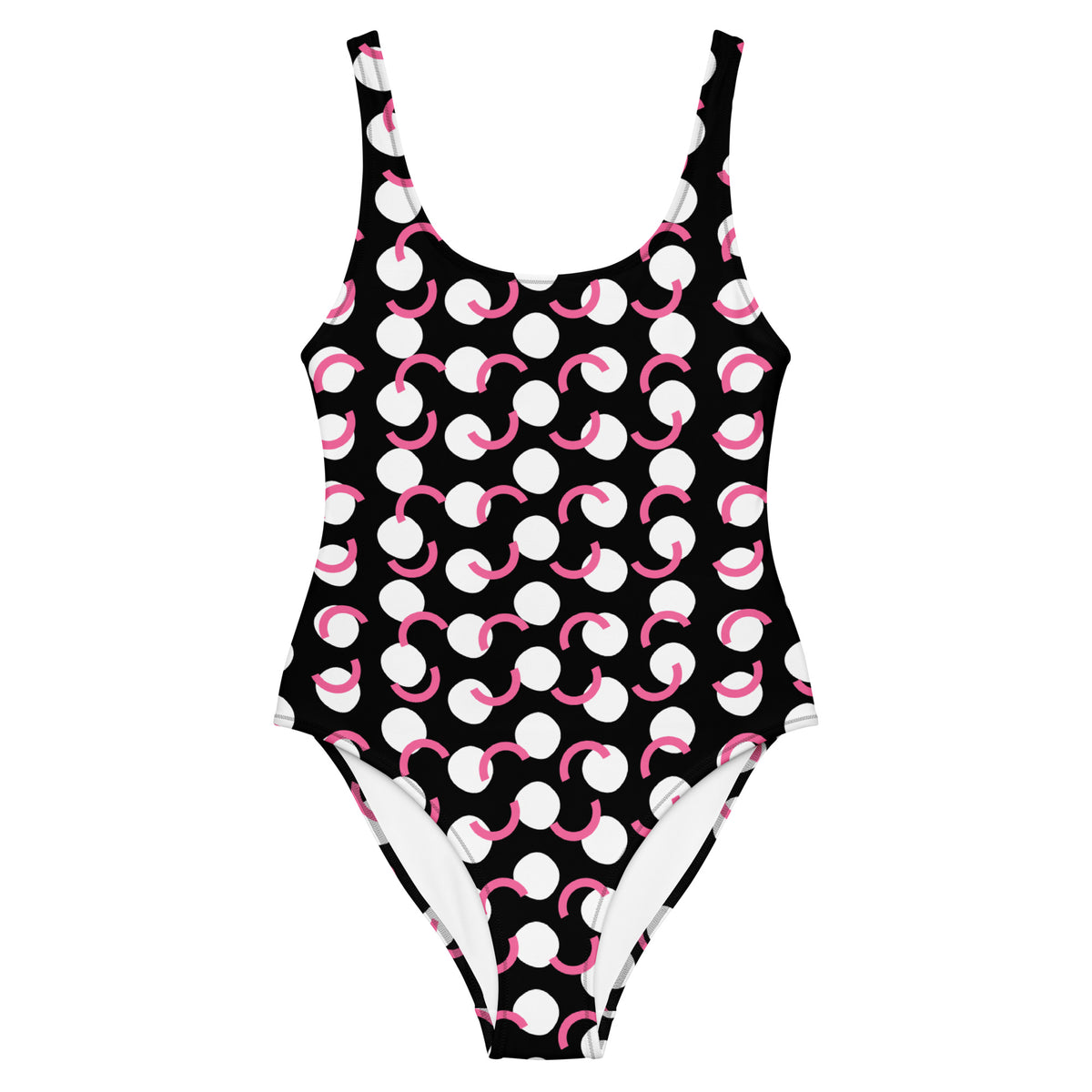 Black one-piece swimsuit with white circles and pink curved polka-dot accents, scoop neckline, and cheeky fit