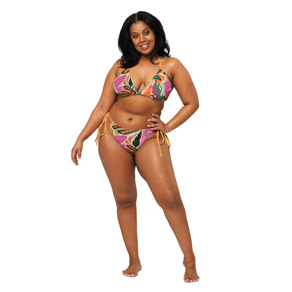 Model wearing Tropical print two-piece string bikini with tangerine ties, triangle top, and tie-side bottoms