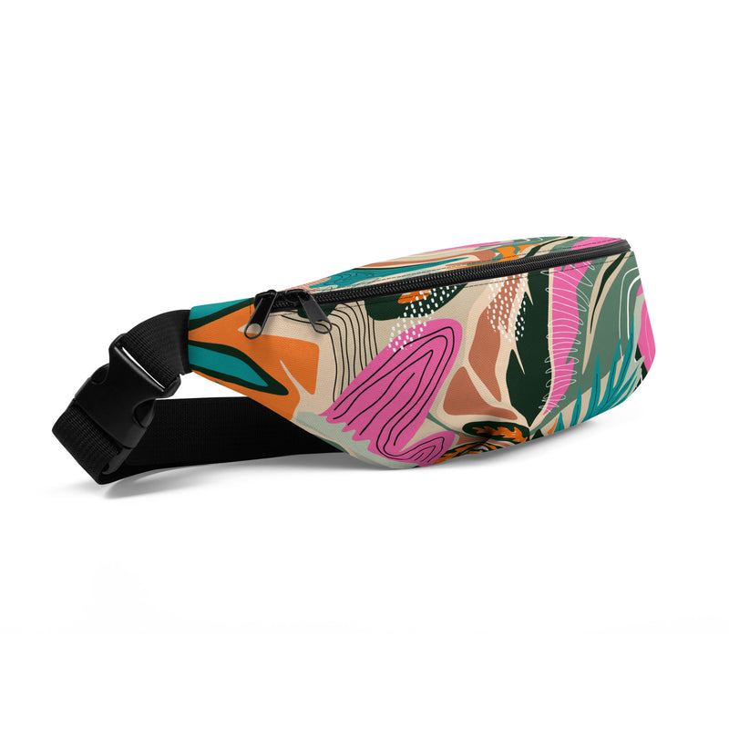 Tropical print fanny pack with tangerine, pink, teal, and green tones worn as a belt bag