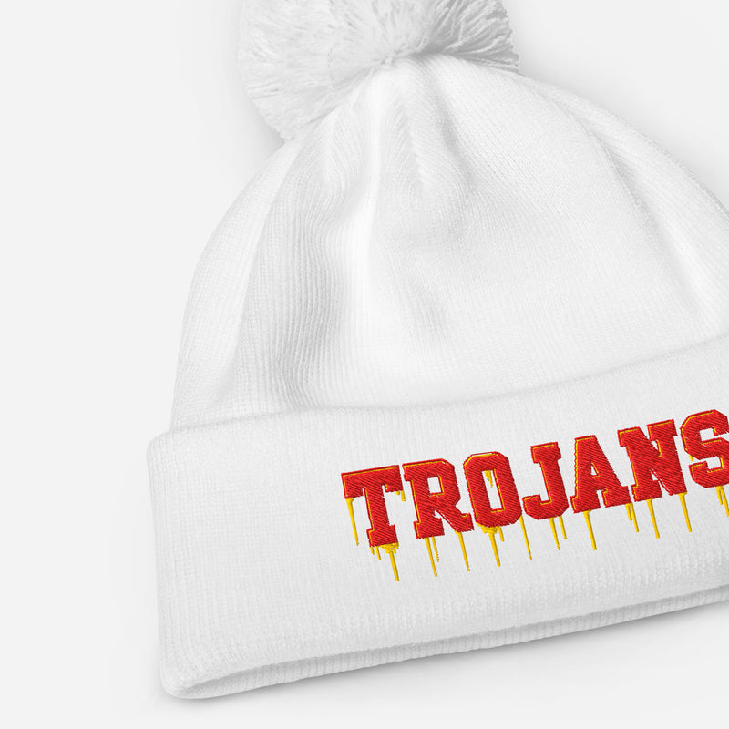 White pom pom beanie with bold embroidered Trojans lettering on the front cuff