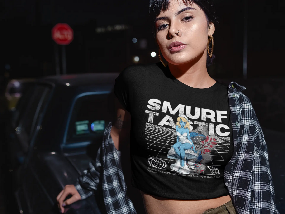 Woman wearing a black t-shirt with 'SMURF TASTIC' graphic design outdoors at night.