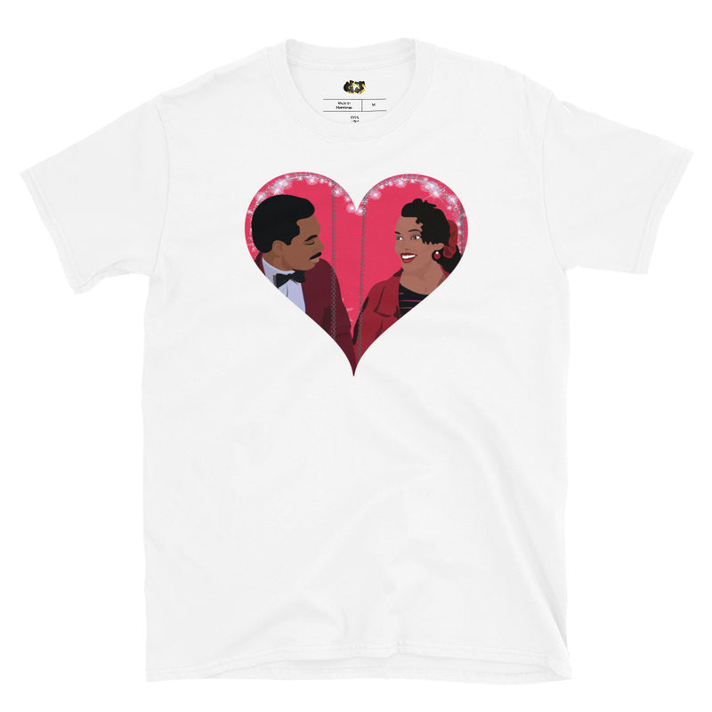 "Royal Love" white t-shirt, featuring a vibrant pop art illustration of Akeem and Lisa McDowell from the iconic film *Coming to America*. This charming design showcases Eddie Murphy and Shari Headley in a heartfelt embrace within a shimmering heart, capturing the magic of their on-screen romance