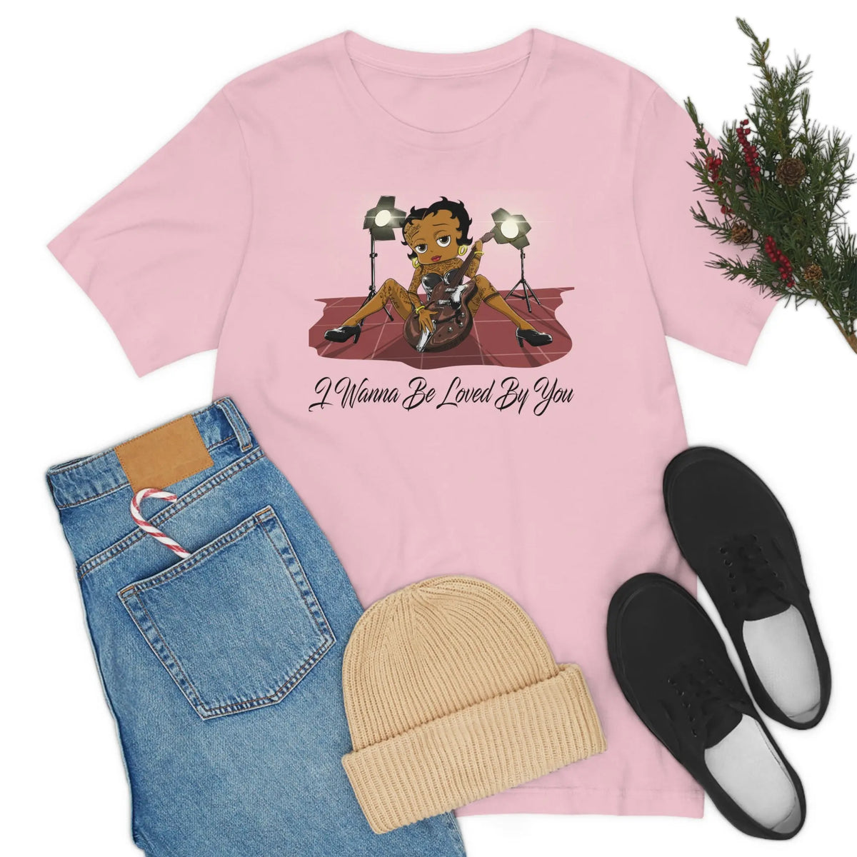 Pink Betty Boop graphic T-shirt featuring her playing an electric guitar under stage lights with I Wanna Be Loved By You text