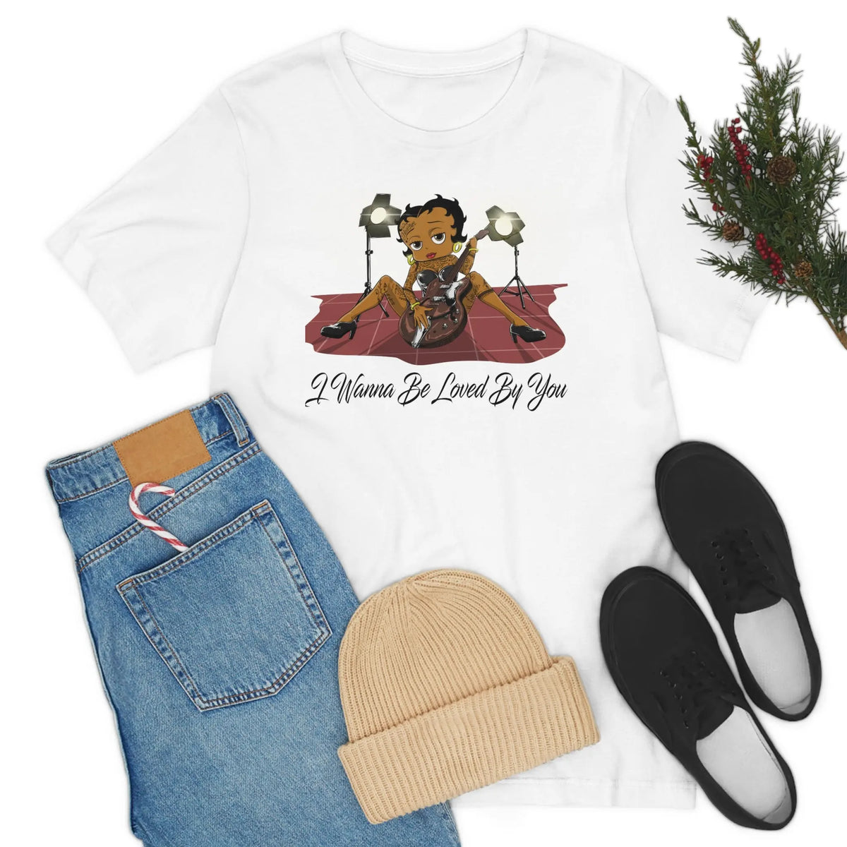 White Betty Boop graphic T-shirt featuring her playing an electric guitar under stage lights with I Wanna Be Loved By You text